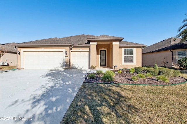 prairie-style house featuring a front lawn and a garage