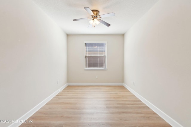 empty room featuring ceiling fan, a textured ceiling, and light wood-type flooring