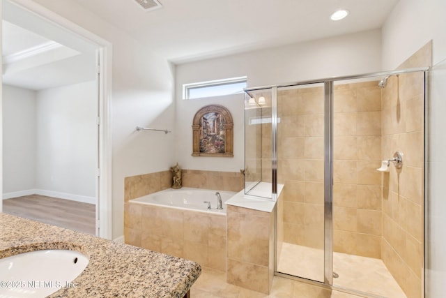 bathroom with sink and shower with separate bathtub