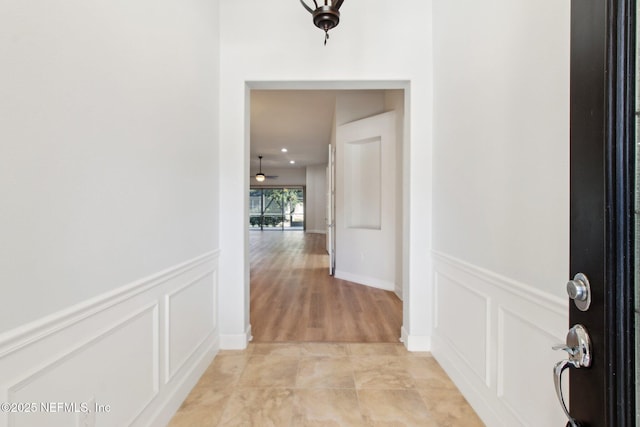 hall with light tile patterned floors