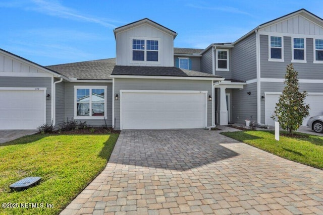 view of front of home featuring a garage and a front lawn