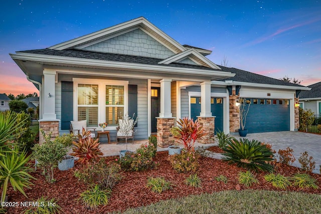 view of front of home with a garage and a porch