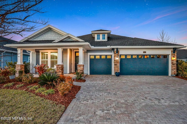 view of front of home with a porch and a garage