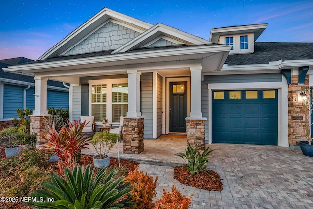 craftsman inspired home with a porch and a garage