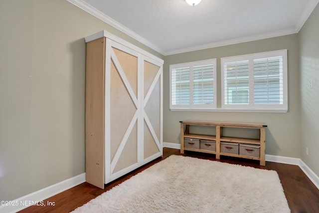 interior space with a healthy amount of sunlight, dark hardwood / wood-style flooring, and crown molding