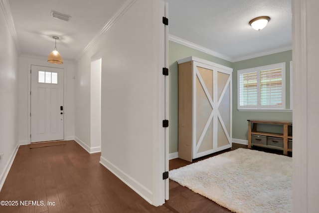 entrance foyer featuring a textured ceiling, crown molding, and dark hardwood / wood-style floors