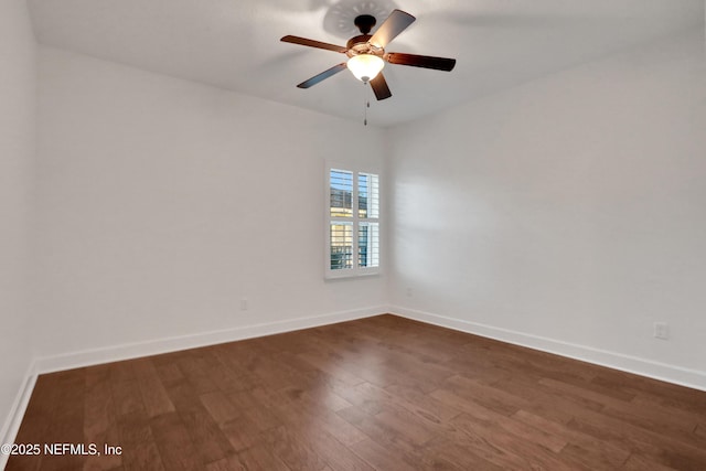 empty room featuring ceiling fan and dark hardwood / wood-style flooring