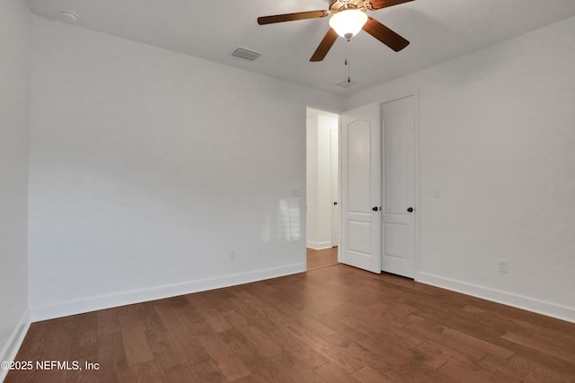 spare room with ceiling fan and wood-type flooring