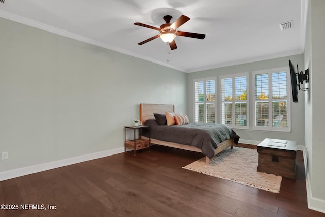 bedroom featuring ceiling fan, dark wood-type flooring, and ornamental molding