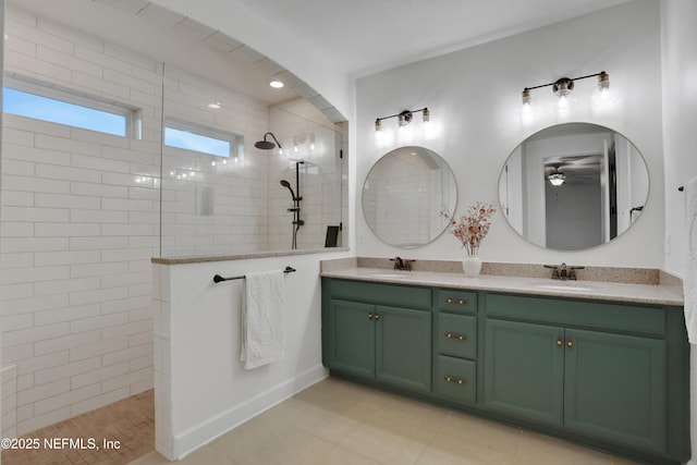 bathroom featuring vanity, tile patterned floors, and tiled shower