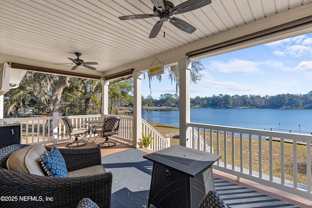 view of patio / terrace with ceiling fan and a water view