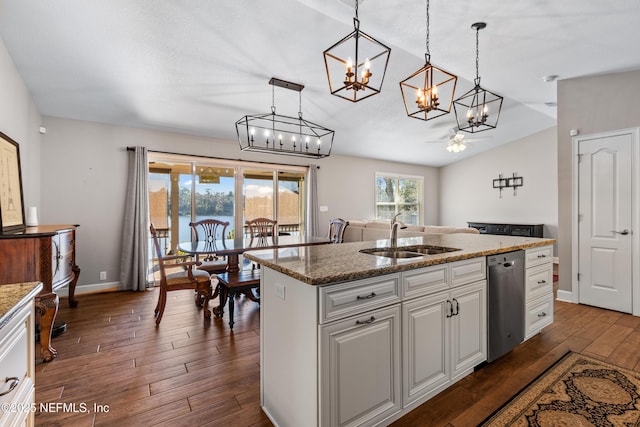 kitchen with pendant lighting, a center island with sink, white cabinetry, ceiling fan, and sink