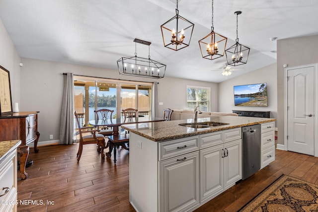 kitchen featuring an island with sink, ceiling fan, pendant lighting, sink, and white cabinetry