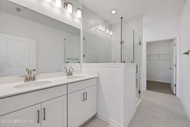 bathroom with vanity and a shower with door