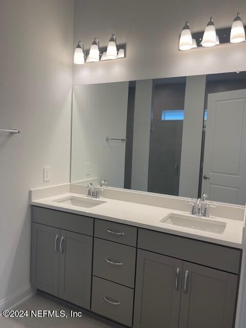 bathroom with tile patterned floors, a shower, and vanity