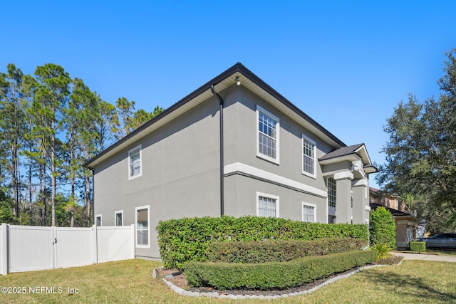 view of side of home with a yard