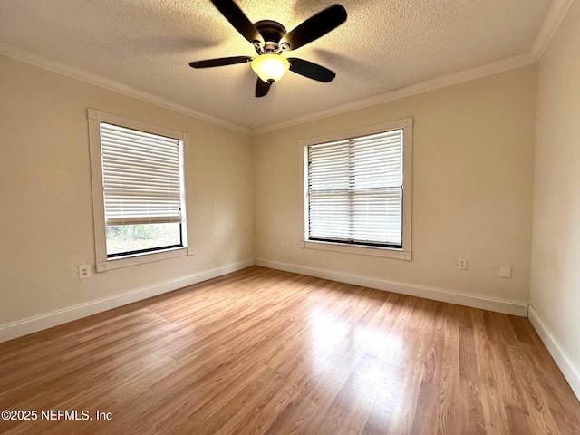 empty room with ceiling fan, light wood-type flooring, crown molding, and a textured ceiling