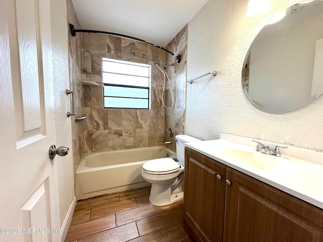 full bathroom with tiled shower / bath combo, vanity, and toilet