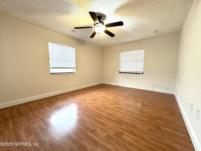 unfurnished room with hardwood / wood-style flooring, a textured ceiling, and ceiling fan