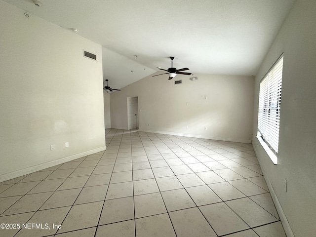 unfurnished room featuring ceiling fan, vaulted ceiling, and light tile patterned flooring