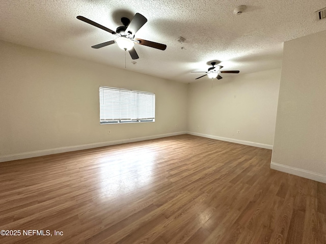 empty room featuring a textured ceiling, ceiling fan, and hardwood / wood-style floors