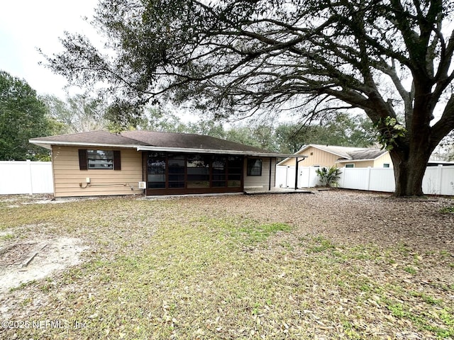 rear view of property with a sunroom