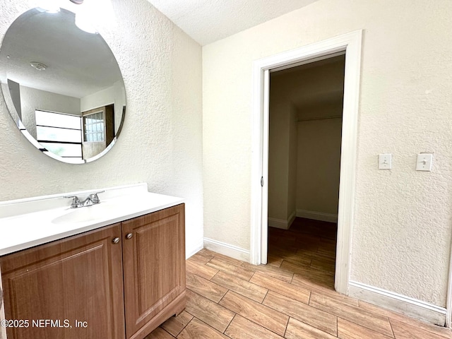 bathroom featuring a textured ceiling and vanity