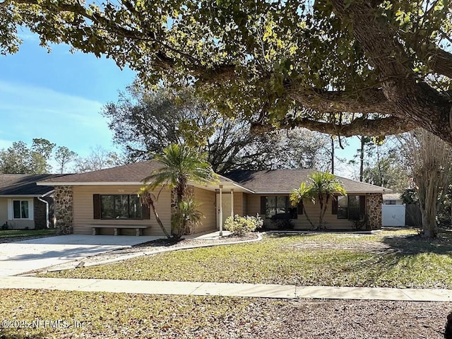 ranch-style house with a garage and a front lawn