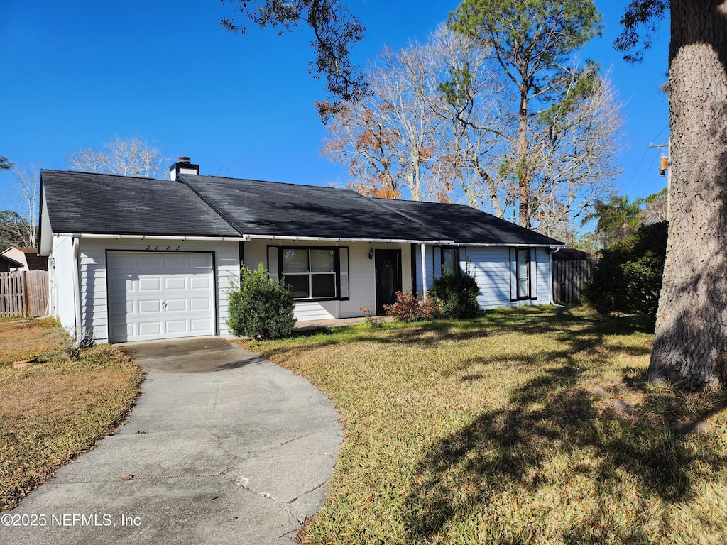 ranch-style home featuring a front yard and a garage