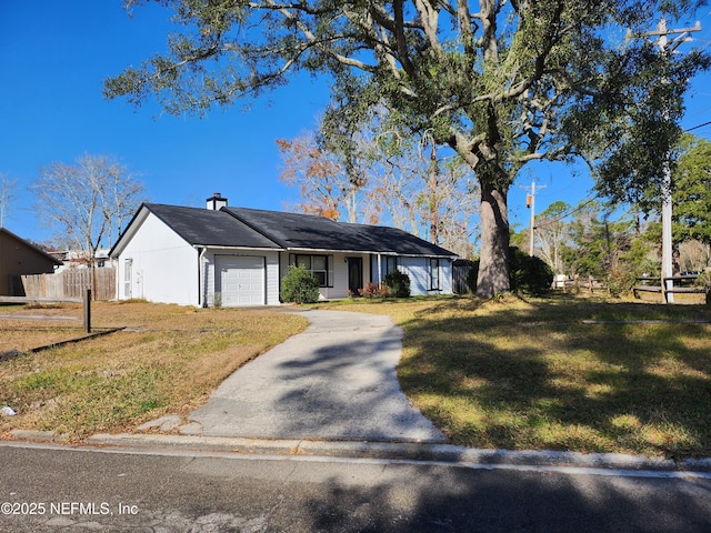 ranch-style home featuring a front yard and a garage