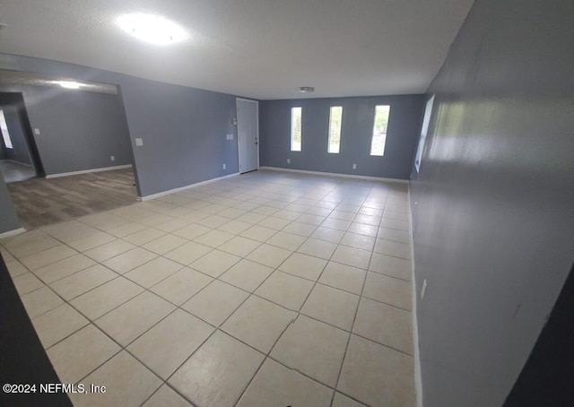 unfurnished room featuring light tile patterned floors