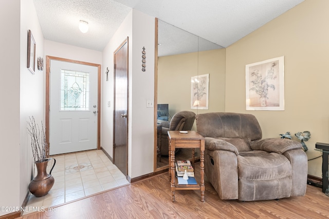 entryway featuring a textured ceiling and light wood-type flooring