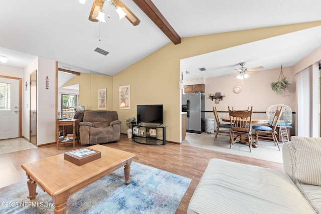 living room with light wood-type flooring, ceiling fan, and lofted ceiling with beams