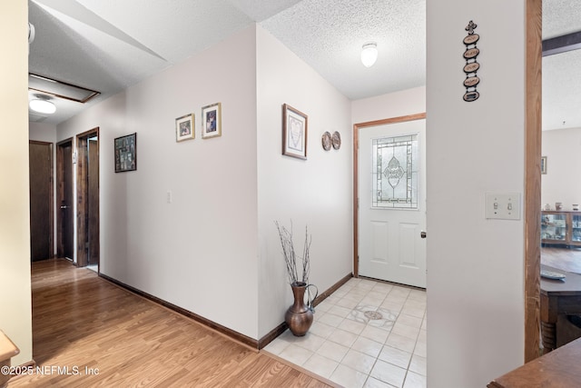 foyer featuring a textured ceiling and light hardwood / wood-style flooring