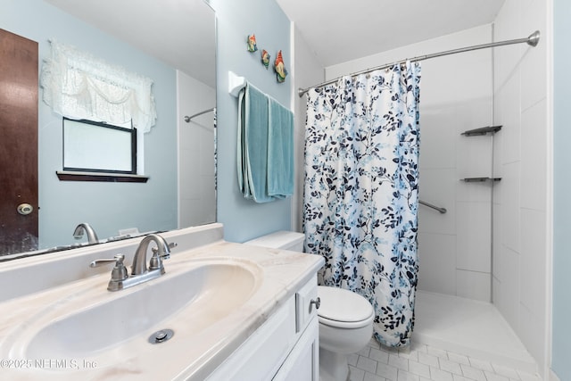 bathroom with toilet, vanity, and a shower with curtain