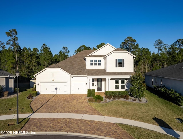 front facade with a garage and a front yard