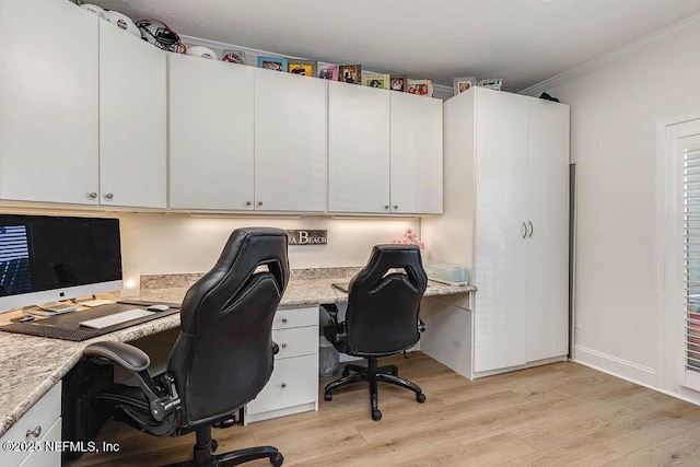 office with light wood-type flooring and ornamental molding