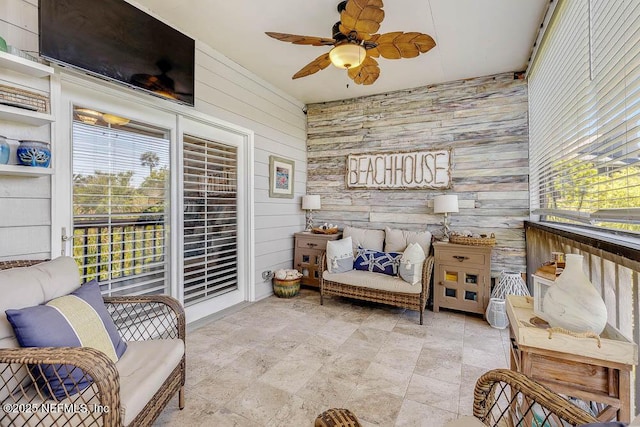 sunroom featuring ceiling fan