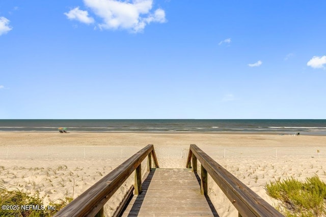 surrounding community featuring a water view and a view of the beach