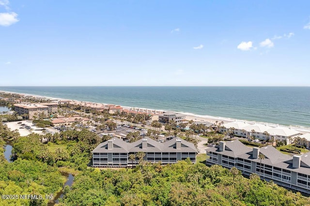 bird's eye view featuring a water view and a beach view