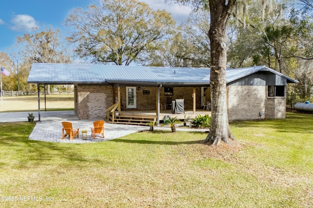 back of house featuring a patio area, a deck, and a yard