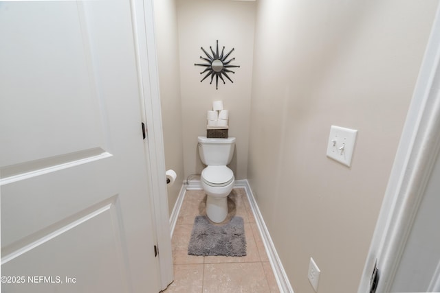 bathroom with toilet and tile patterned floors