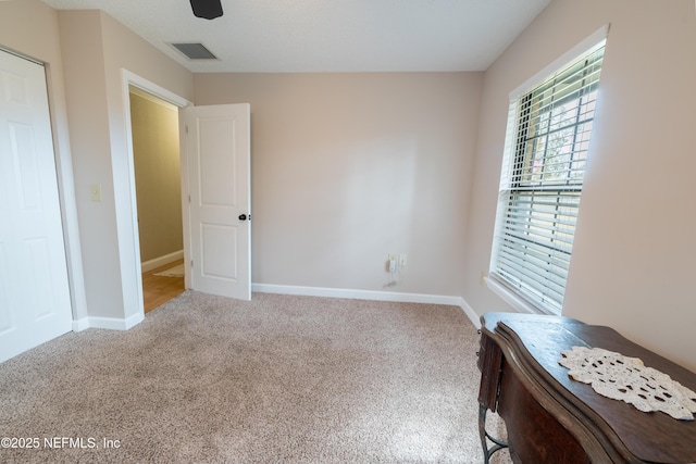 unfurnished bedroom featuring carpet and ceiling fan