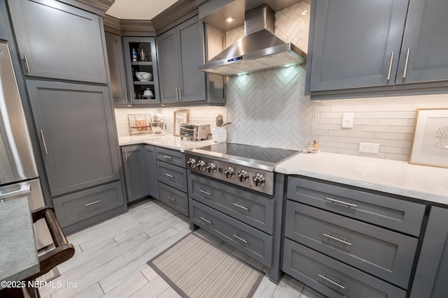 kitchen with gray cabinets and range hood