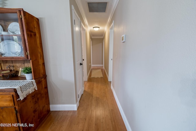 corridor featuring crown molding and light wood-type flooring