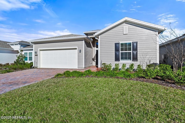 view of front of property with a front lawn and a garage