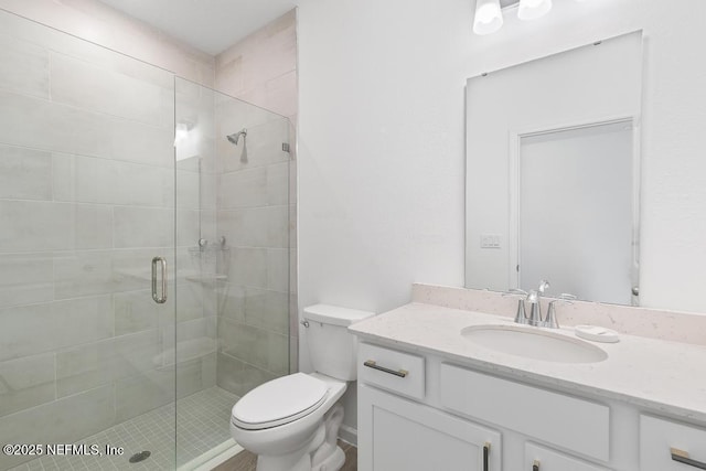 bathroom with walk in shower, vanity, and toilet