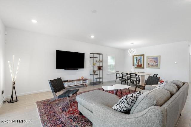 living room with a chandelier and light hardwood / wood-style flooring