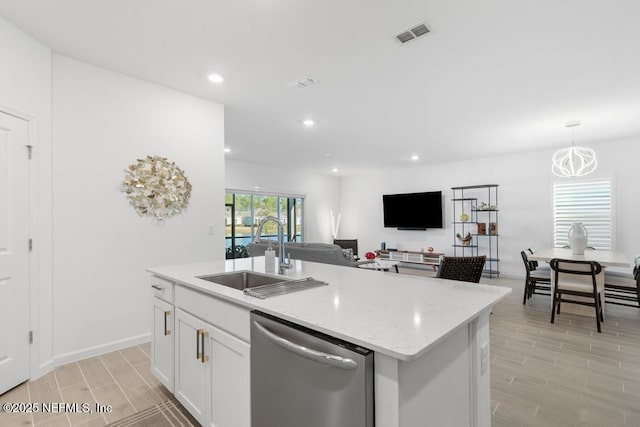 kitchen featuring white cabinets, a kitchen island with sink, pendant lighting, sink, and stainless steel dishwasher