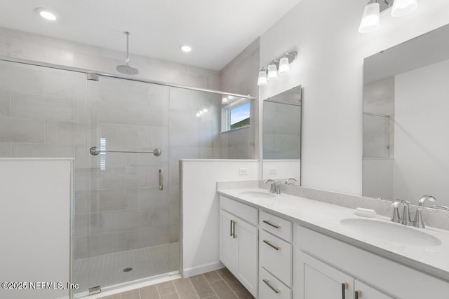 bathroom with a shower with door and vanity